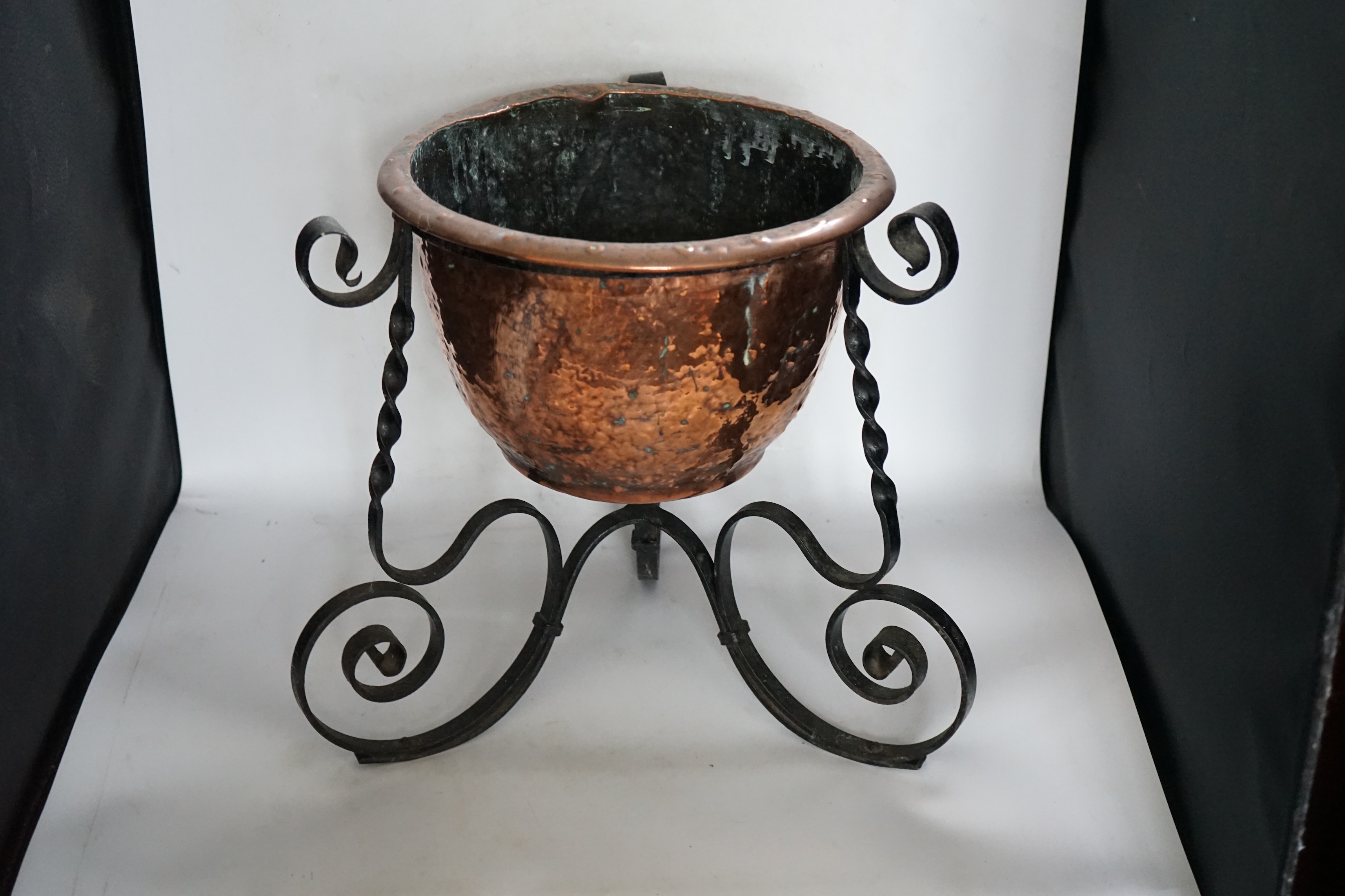 An Edwardian wrought iron and copper jardiniere